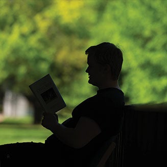 Person reading on campus